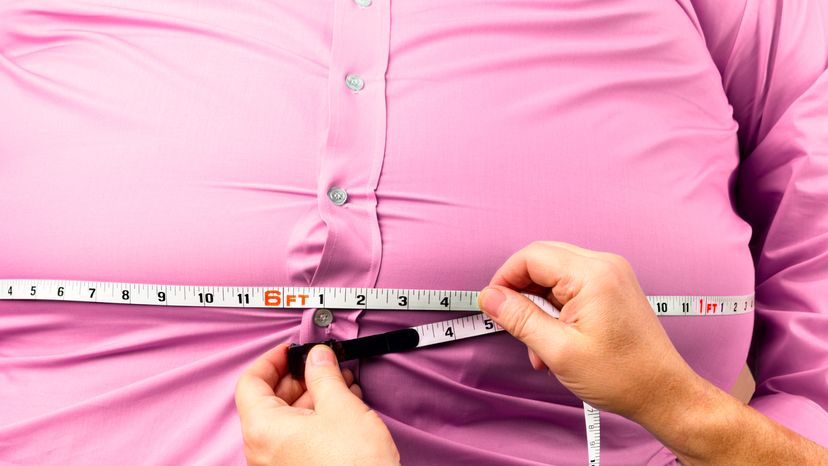 Checking the waist of an obese